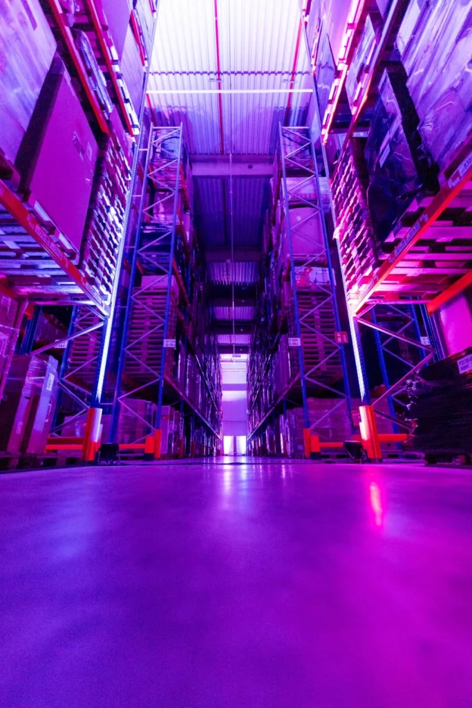 Sound Patrol Avides Media 25 Jahre: Lagerhalle als Eventlocation für das Firmenjubiläum mit violettem Uplighting und Bühne